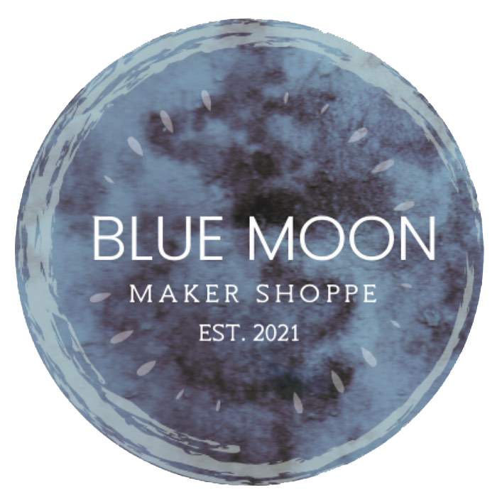 Circle with various blues that looks like the surface of the moon with the text "Blue Moon Maker Shoppe logo, est. 2021"