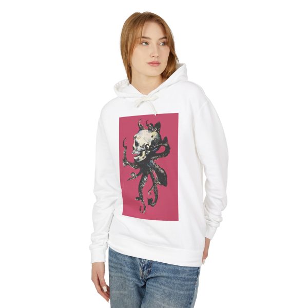 Woman wearing white hoodie with abstract skull design.