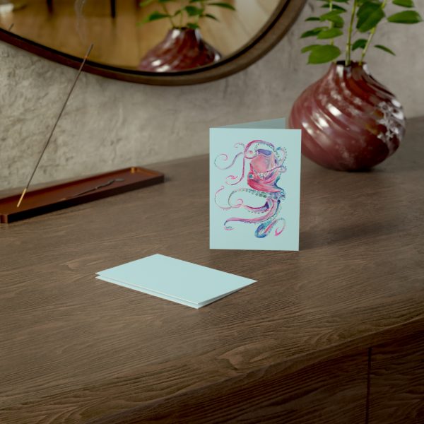 Greeting card with octopus on wooden table