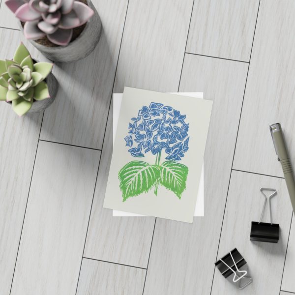 Succulents with blue flower card on wood floor